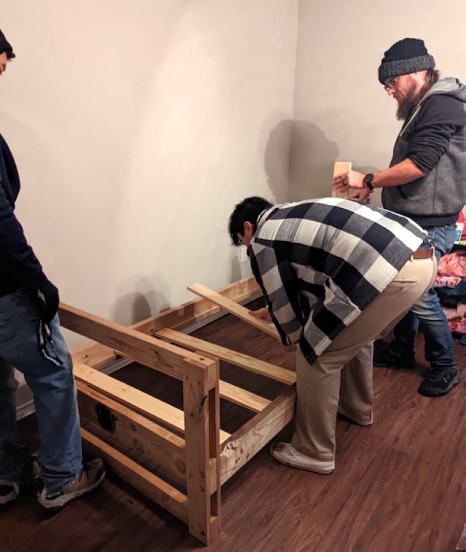 With recipients’ permission, volunteers assemble beds for the children. Beds can be assembled separately or as bunk beds. (Jishnu Nair/Community Impact Newspaper)