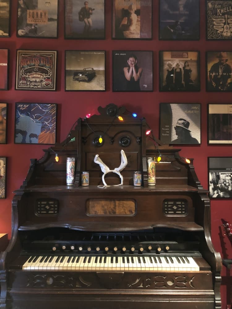 A wall of records shows artists who have recorded at Cedar Creek Recording. (Glorie Martinez/Community Impact Newspaper)