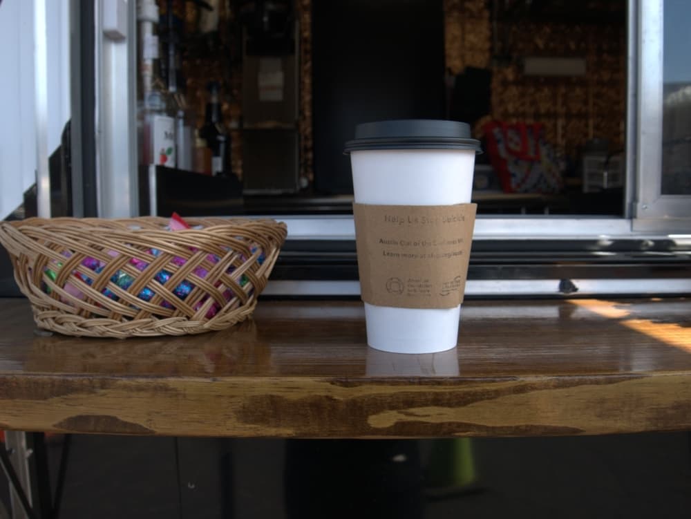 The coffee sleeves feature the American Association of Suicide Prevention’s website. (Glorie Martinez/Community Impact Newspaper)