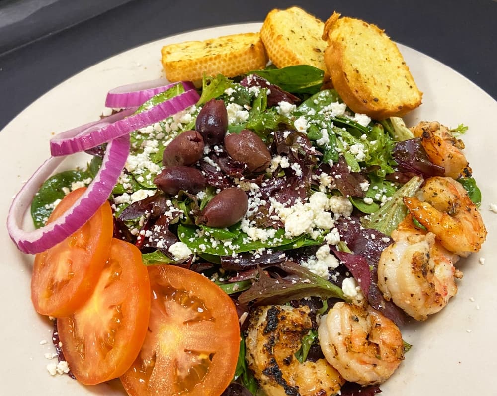 Grilled shrimp salad ($10.95): Greens are topped with feta cheese, olives, tomato, garlic toast and balsamic vinaigrette. (Courtesy Amedeo's Italian Restaurant)