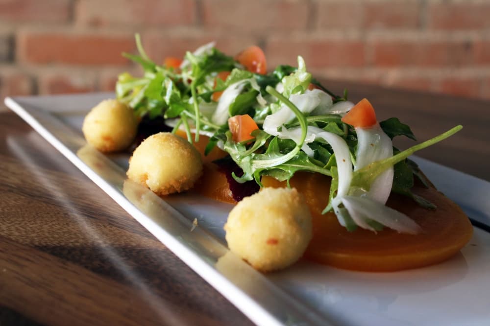 Roasted Beet Salad ($13) has arugula, fennel, cherry tomatoes, fried goat cheese and champagne vinaigrette. (Karen Chaney/Community Impact Newspaper)