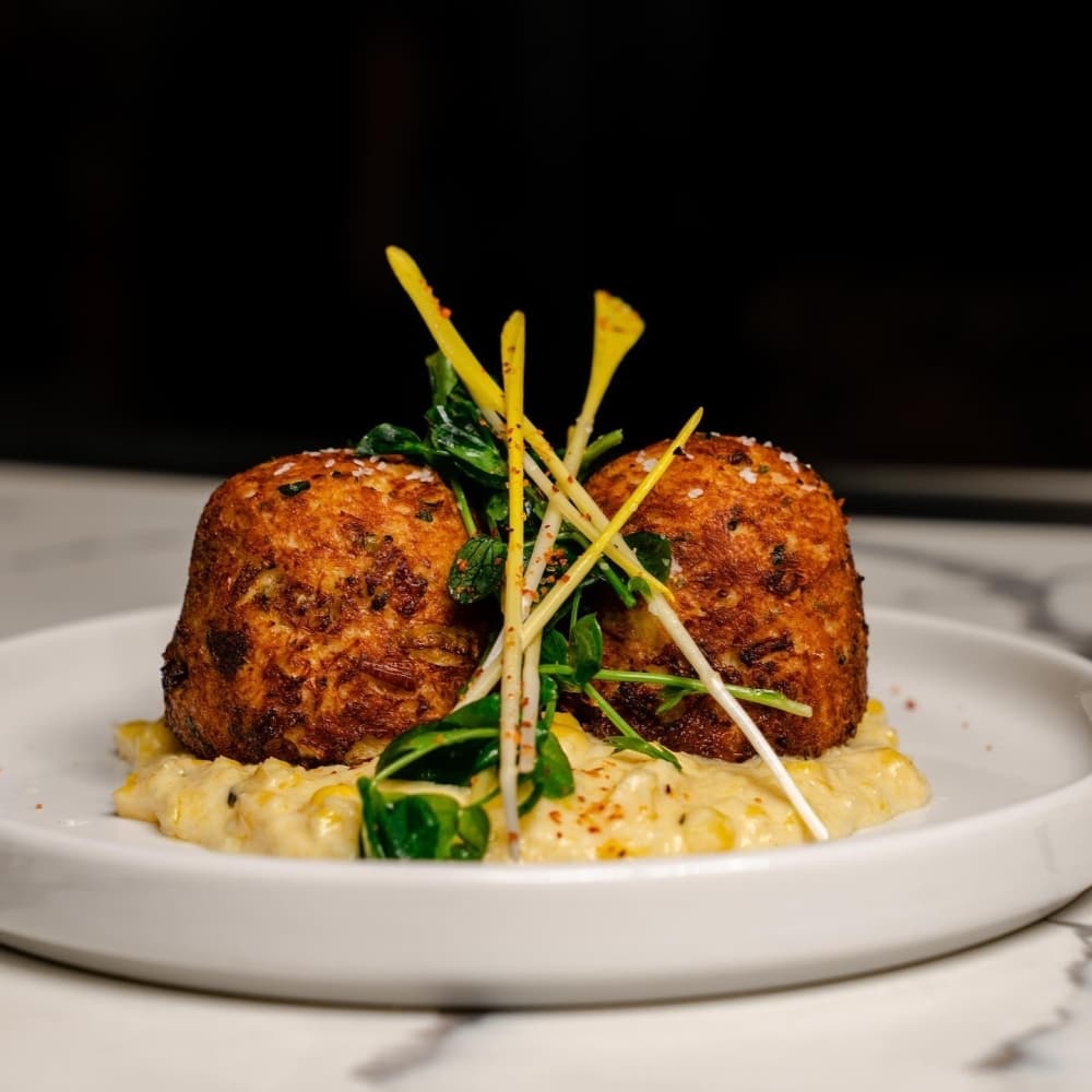 Crab cakes ($21): lump crab, cream corn, corn shoots; pairs well with Sean Minor Chardonnay (Courtesy Pearl and Vine)