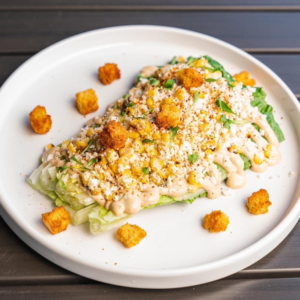 ‘Elote’ caesar ($11): heart of romaine, caesar, grilled corn, cilantro, cornbread crouton, cotija, tajin; pairs well with Alexana 2018 Estate Pinot Noir Dundee Hills-Willamette Valley, Oregon (Courtesy Pearl and Vine)