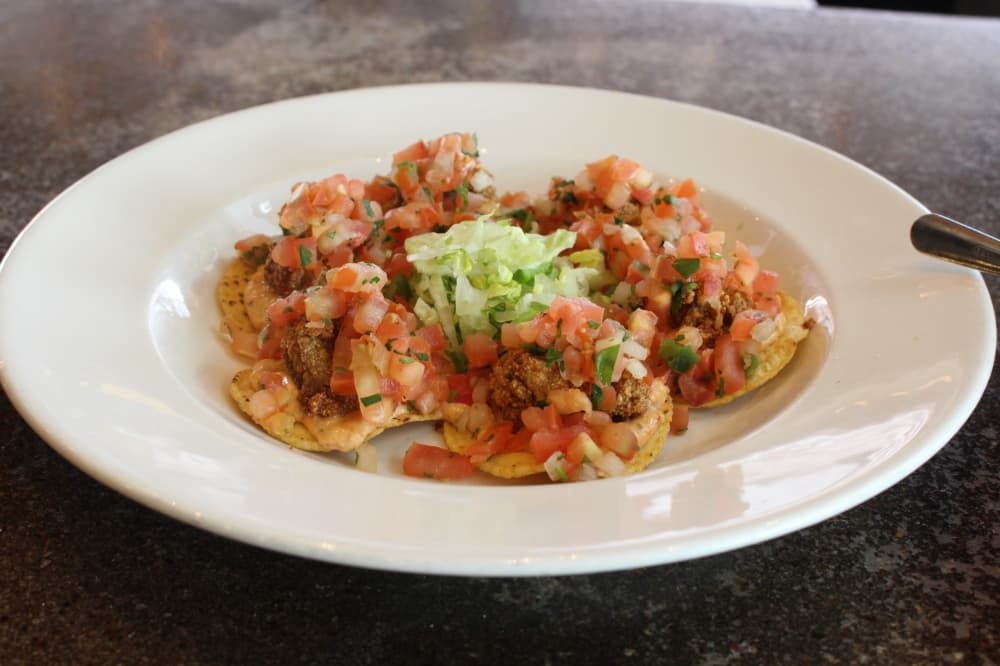 Oyster nachos ($11.49) are a seafood twist on a Tex-Mex classic. This dish includes fried oysters, chipotle tartar sauce and fresh pico de gallo. (Jackson King/Community Impact Newspaper)