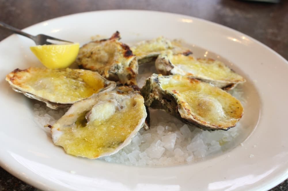 Chargrilled oysters ($14.99) are served with lemon pepper butter and Parmesan cheese. (Jackson King/Community Impact Newspaper)