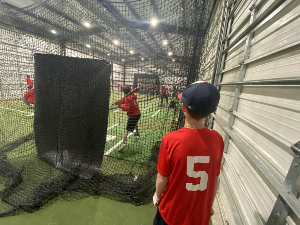 A 12-and-under-player waits for his turn at batting practice at the Round Rock facility. 