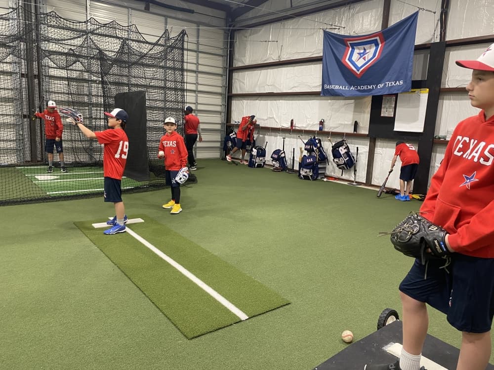 Baseball Academy of Texas players practice fielding techniques. 