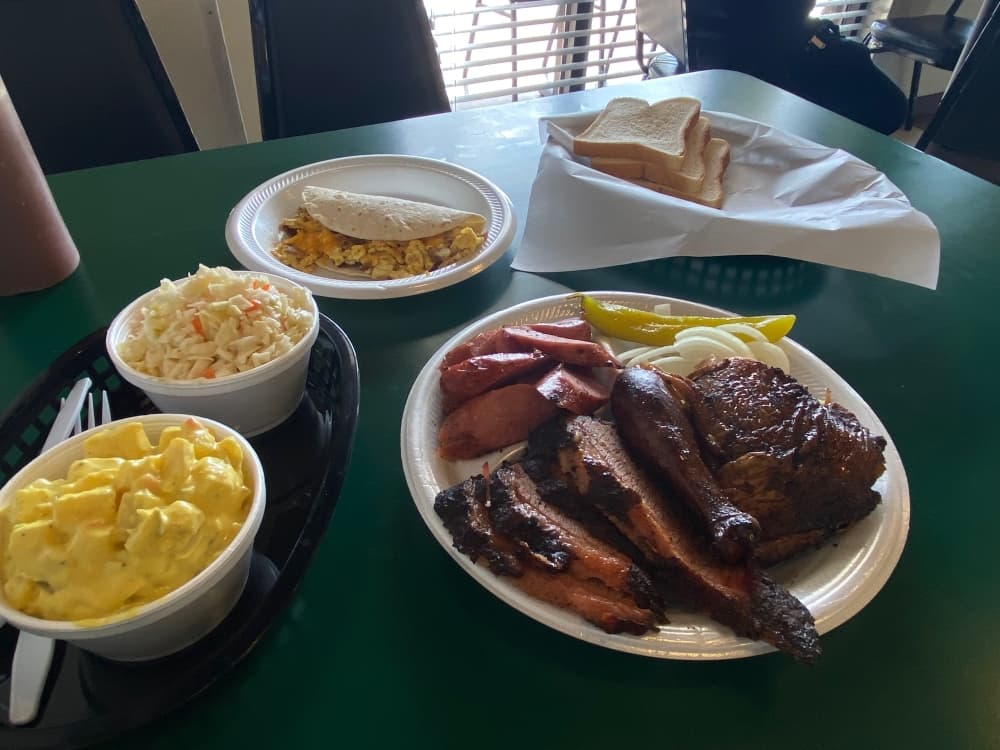 The three meat plate featuring brisket, chicken and sausage comes with two sides. Pictured here are potato salad and coleslaw. $15.99 (Brooke Sjoberg/Community Impact Newspaper)