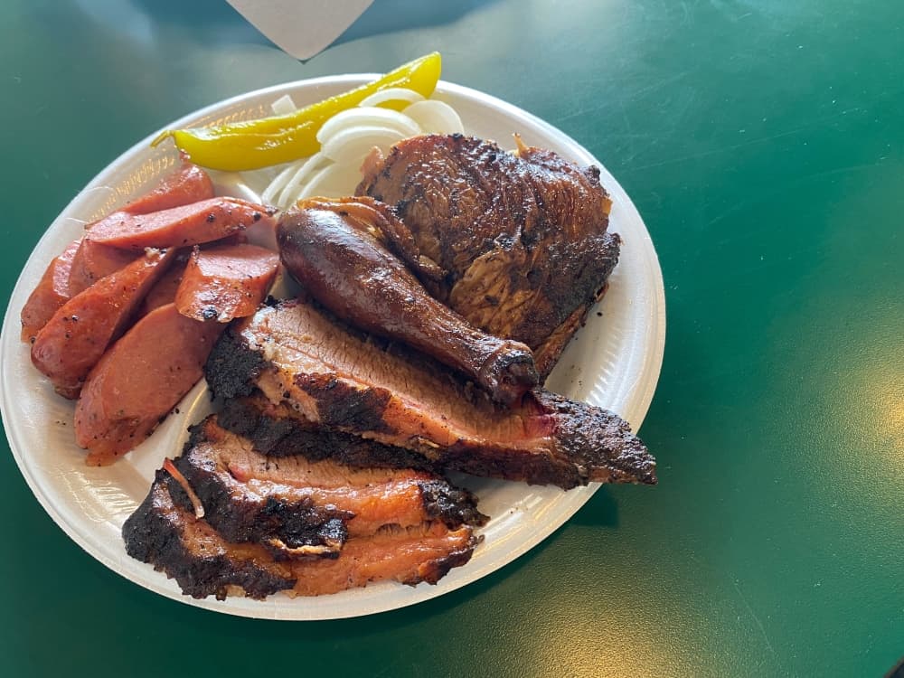 The three meat plate featuring brisket, chicken and sausage comes with two sides. $15.99 (Brooke Sjoberg/Community Impact Newspaper)