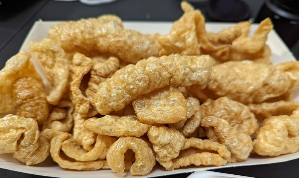 Chicharrones ($5.99): Large, fried pork rinds are served with four ounces of guacamole and four ounces of salsa. (George Wiebe/Community Impact Website)