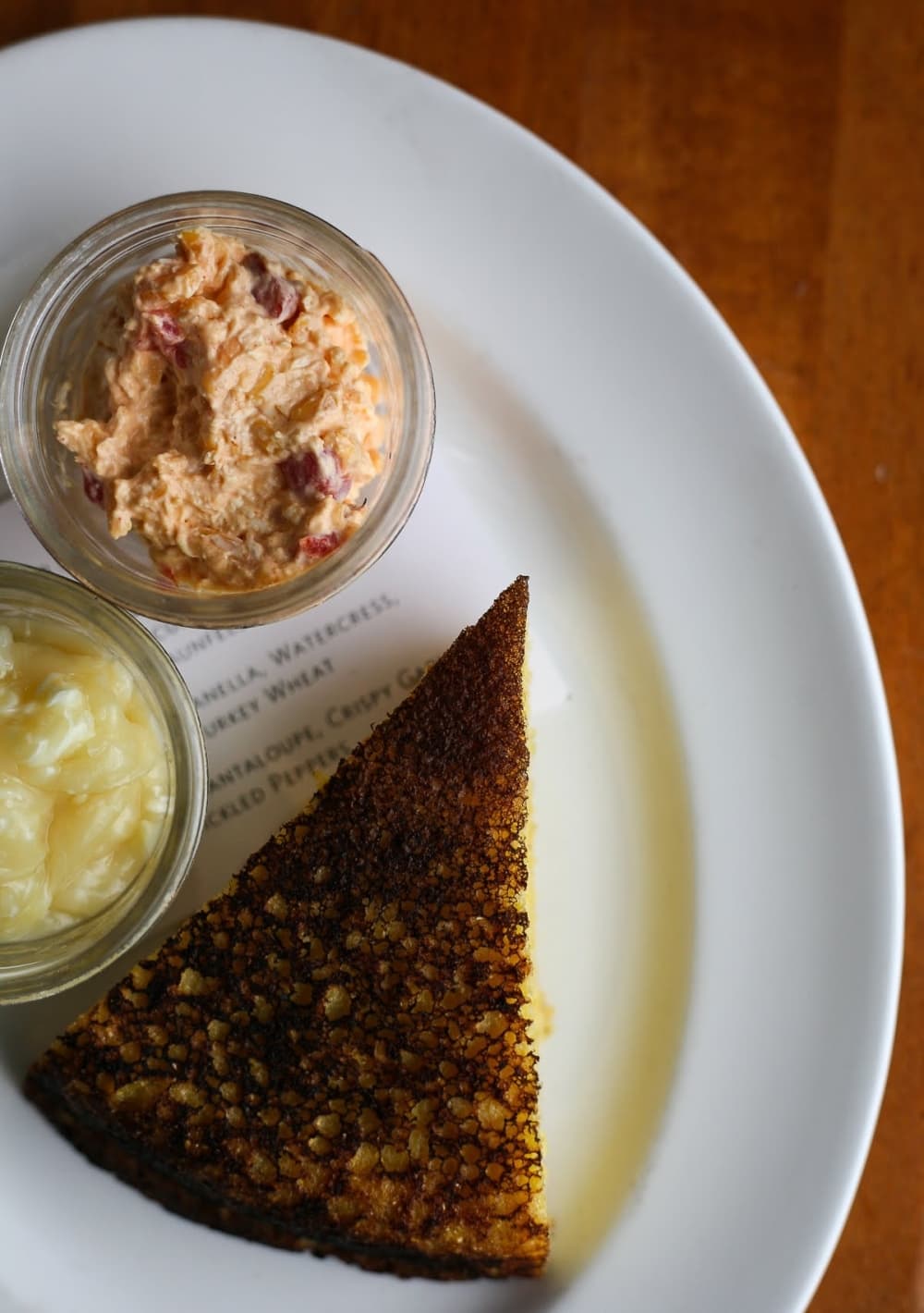 Wood Oven Cornbread ($7) Fresh cornbread is served with honey lard butter and jalapeno pimento cheese.