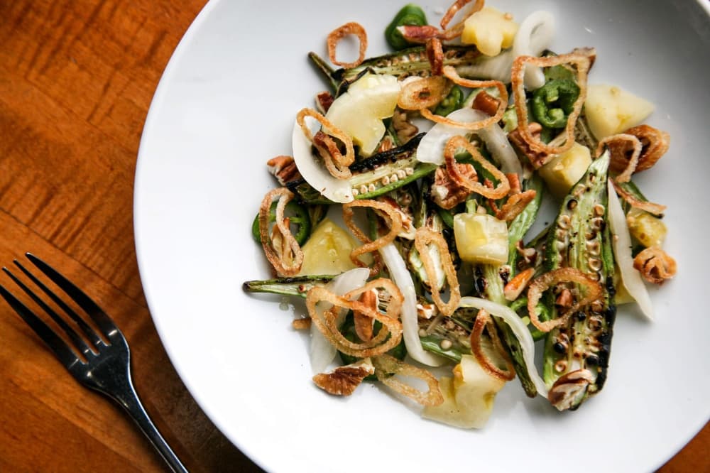 Grilled Okra ($10) (currently out of season) This popular dish includes okra, pickled green tomatoes, Texas pecans and crispy shallots.
