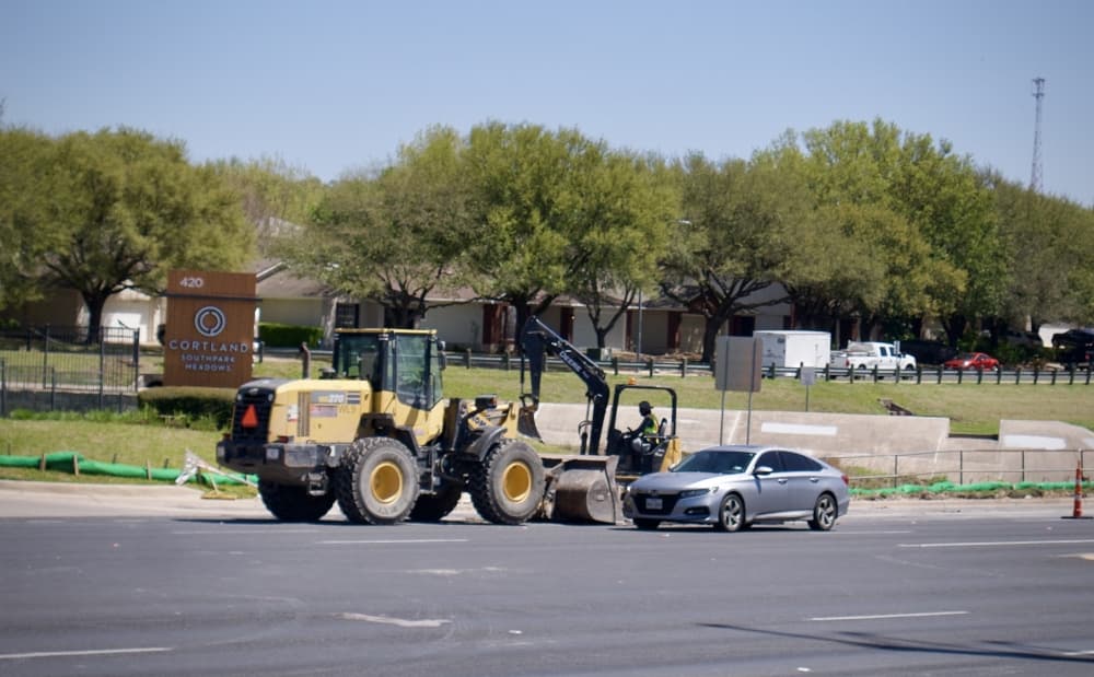 Crews work on sidewalks along Slaughter Lane. (Glorie Martinez/Community Impact Newspaper)