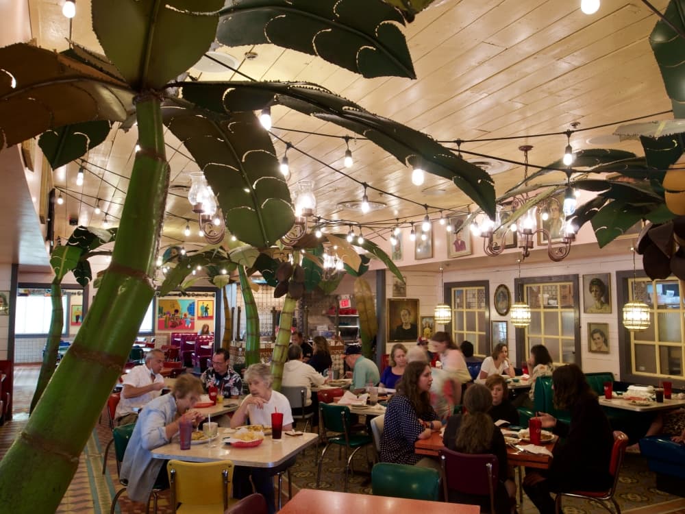 The South Austin Chuy's features a colorful dining room with fake palm trees. (Glorie Martinez/Community Impact Newspaper staff)