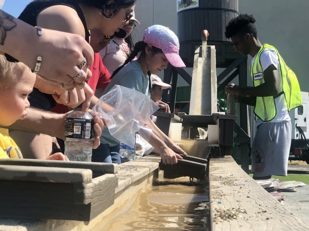 Sift through sand in the 24-foot sluice to find gems at the The Gem Mining Station attraction. (Asia Armour/Community Impact Newspaper)