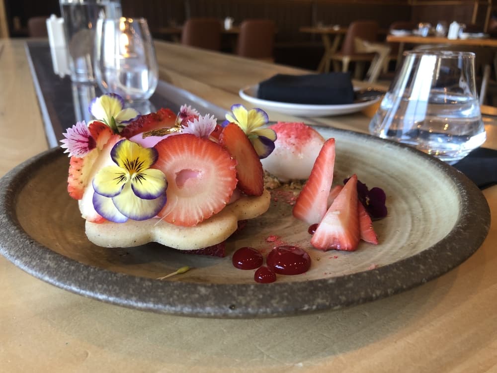 The colorful Ichigo tart ($16) is composed of strawberry mousse and compote, vanilla pastry ice cream, a black pepper sable cookie and milk sorbet. (Asia Armour/Community Impact Newspaper)