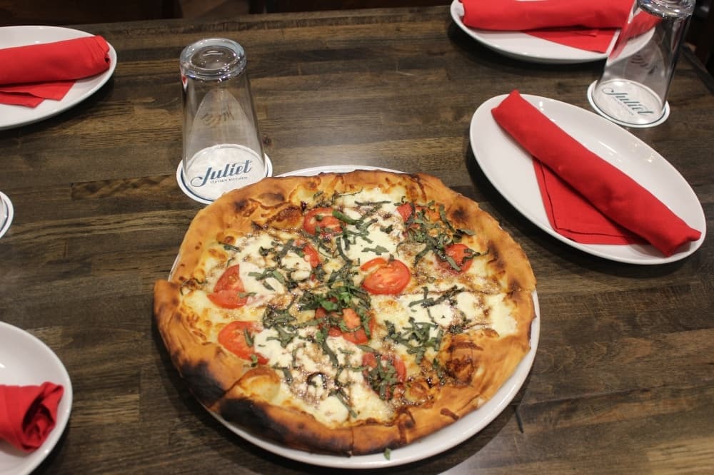 A margherita pizza is topped with tomato, mozzarella, basil and balsamic vinegar. ($14) (Claire Shoop/Community Impact Newspaper)