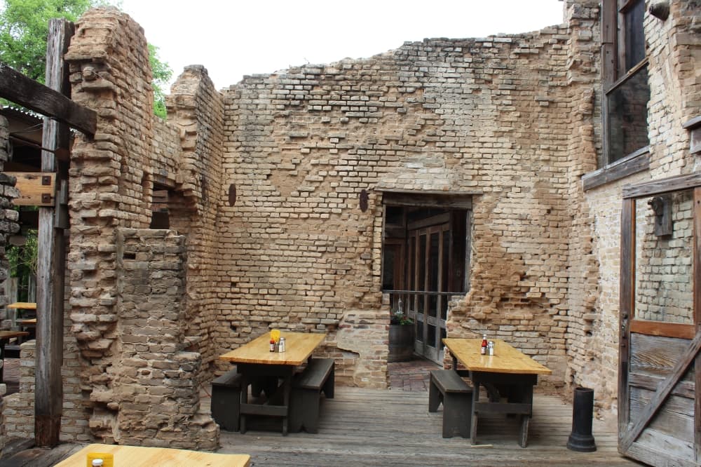 Throughout the many levels of the restaurant along the banks of the Guadalupe River, diners can sit within the ruins of the old cotton gin.