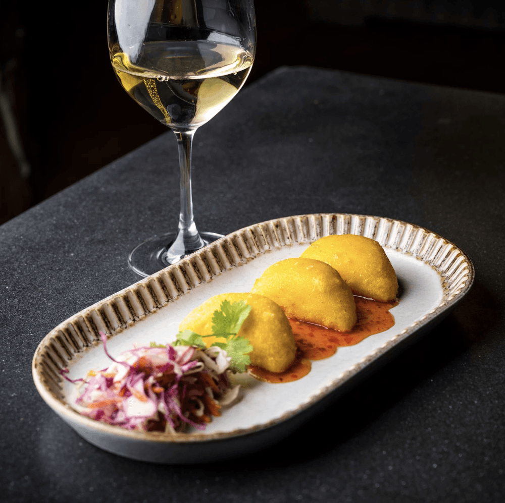 A fan-favorite Stone House Restaurant shareable, or appetizer, is its blue crab empanadas with fire roasted pepper jelly. (Courtesy Stone House Restaurant)