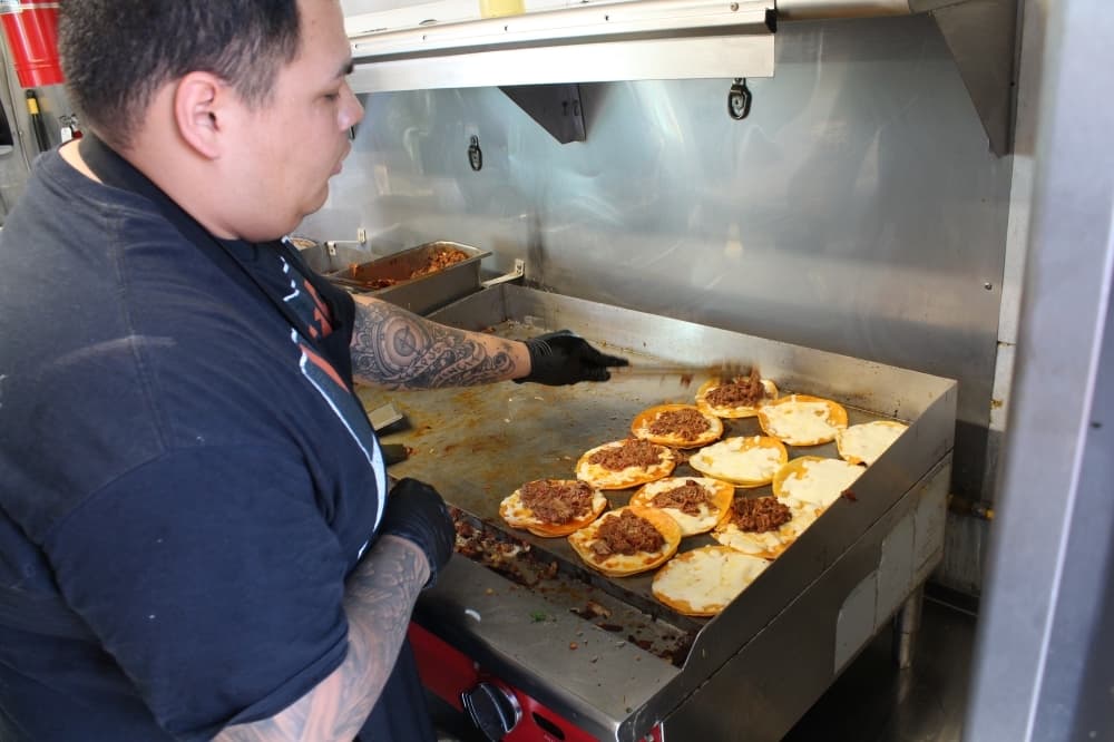 
Jose Hernandez works the grill making birria tacos at the Buda location.