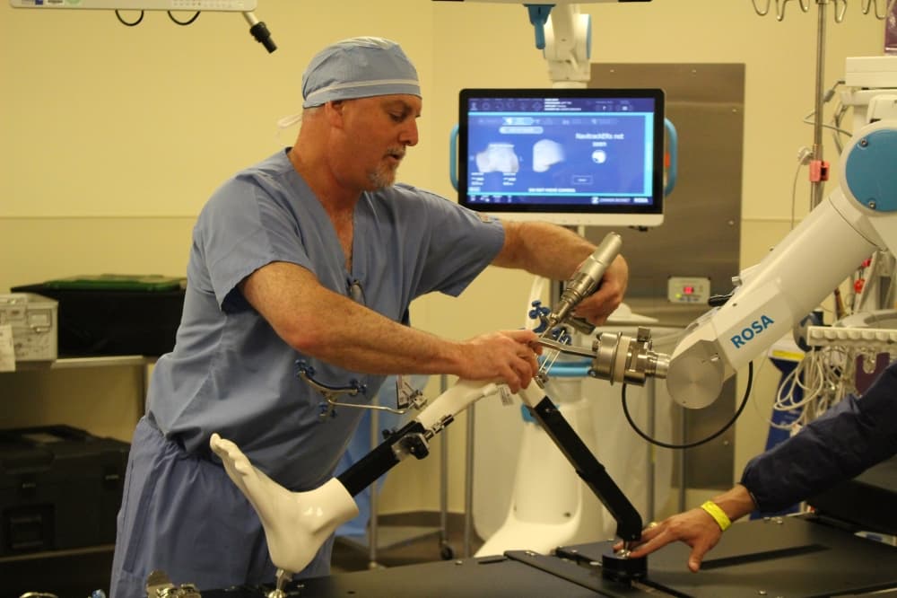 Dr. Eric Price demonstrated how the hospital uses robotic surgical assistants to aid in orthopedic surgeries. (Andrew Christman/Community Impact Newspaper)