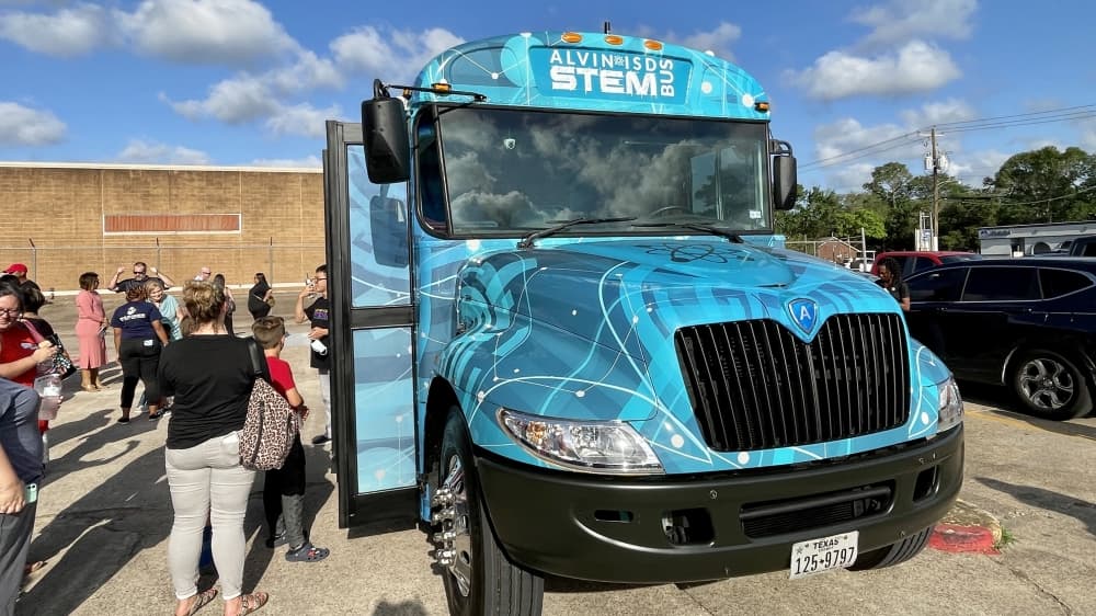 Representatives from Pearland, Manvel, Alvin and the state were present for the Alvin ISD STEM Explorer Bus' unveiling ceremony. (Andy Yanez/Community Impact Newspaper)