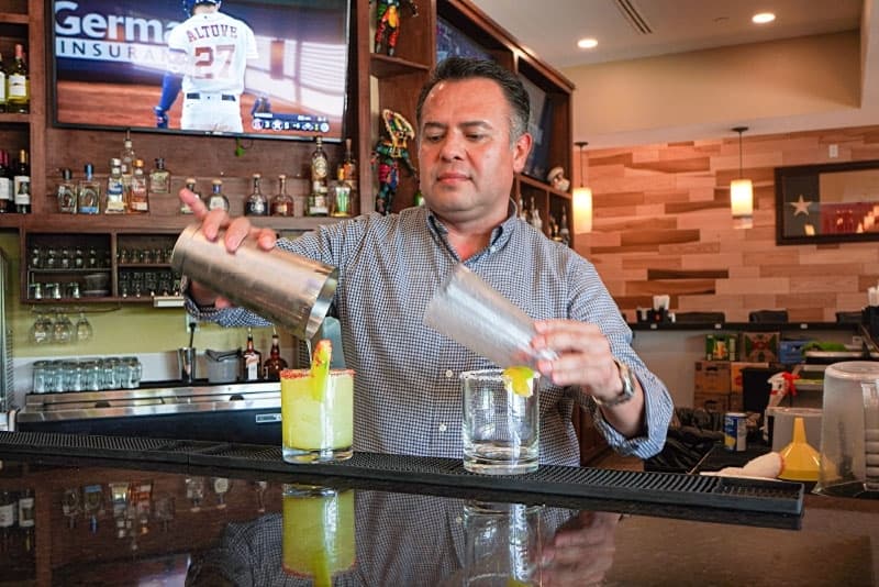 Owner Efrain Hernandez crafts summer cocktails. (Christopher Goodwin/Community Impact Newspaper)