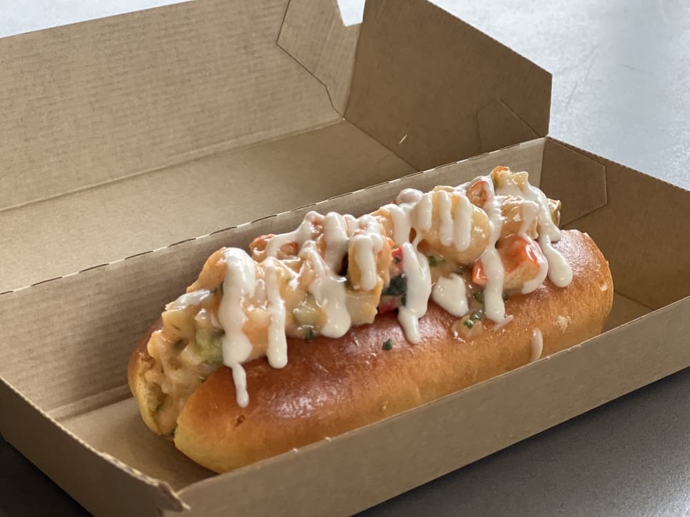 Savory hot dog-esque treats are offered on brioche buns with toppings and fillings. (Grace Dickens/Community Impact Newspaper)