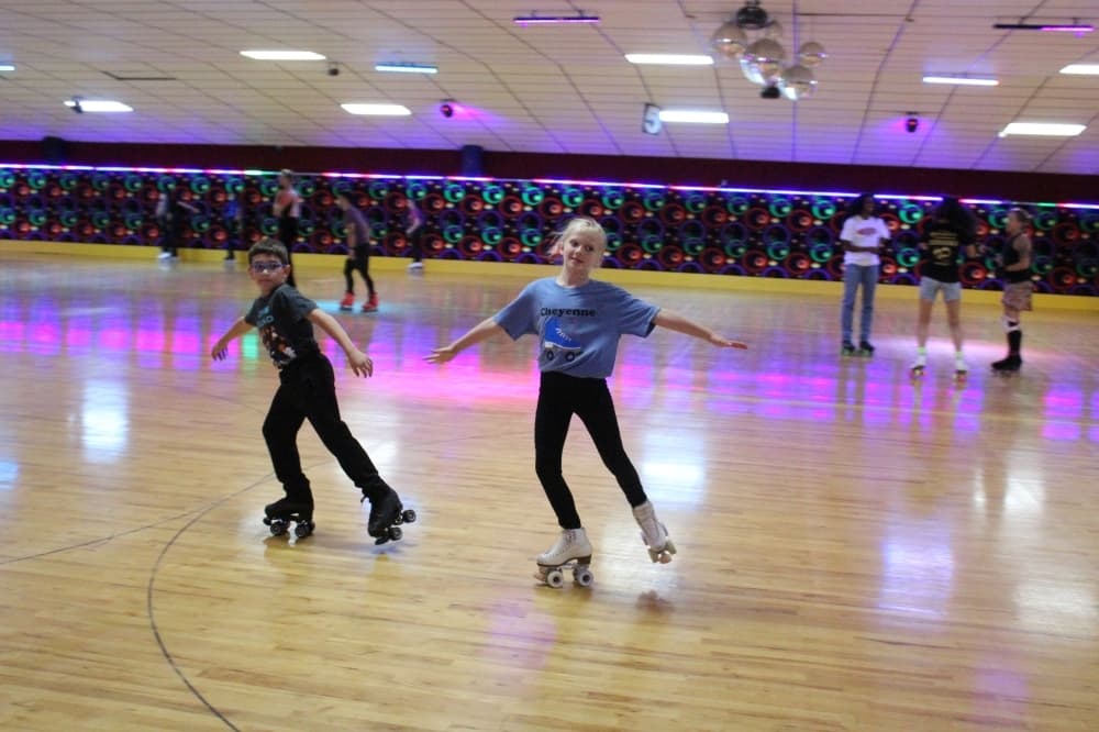 Jacen Langely and Cheyenne Kirby slide across the rink March 31. (Emily Lincke/Community Impact Newspaper)