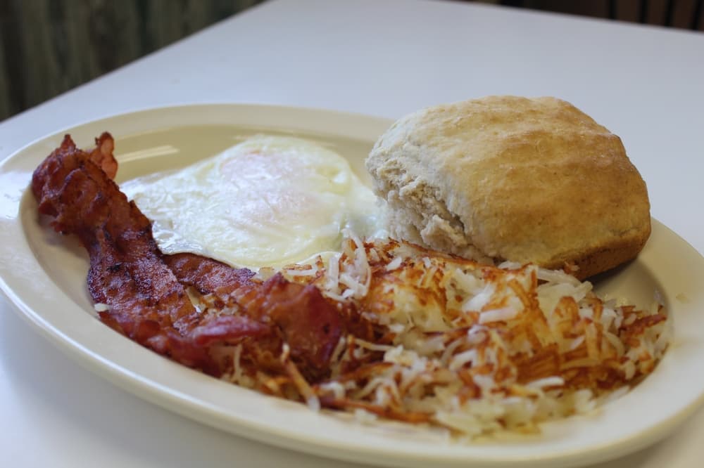 two over-easy eggs, hashbrowns, bacon and a biscuit
