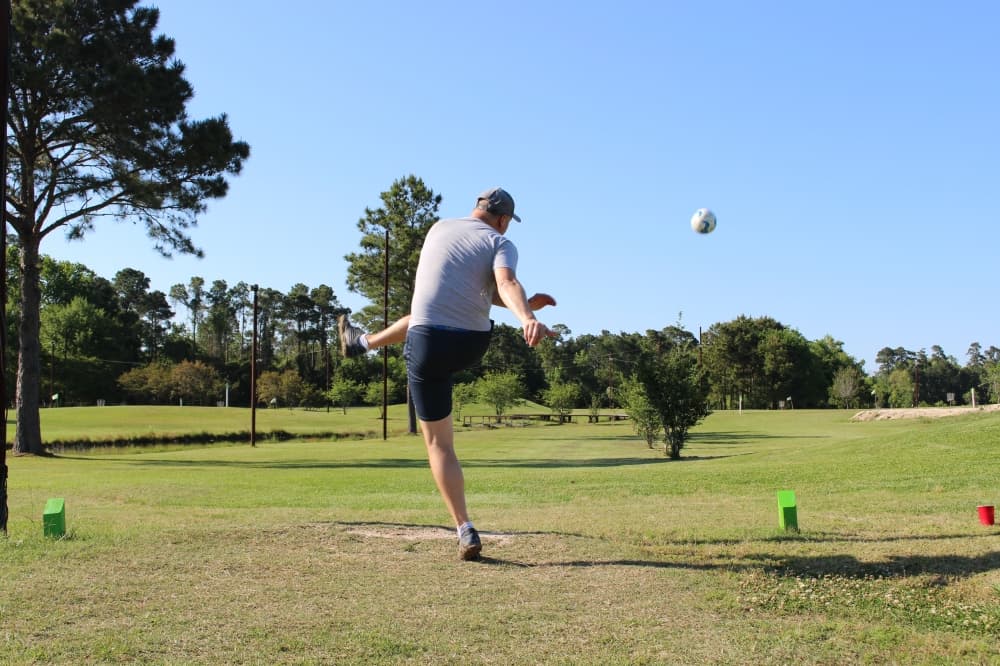 Humble SportsPlex patron Ian MacNaughton launches a soccer ball from the tee box during a game of foot golf. (Wesley Gardner/Community Impact Newspaper)