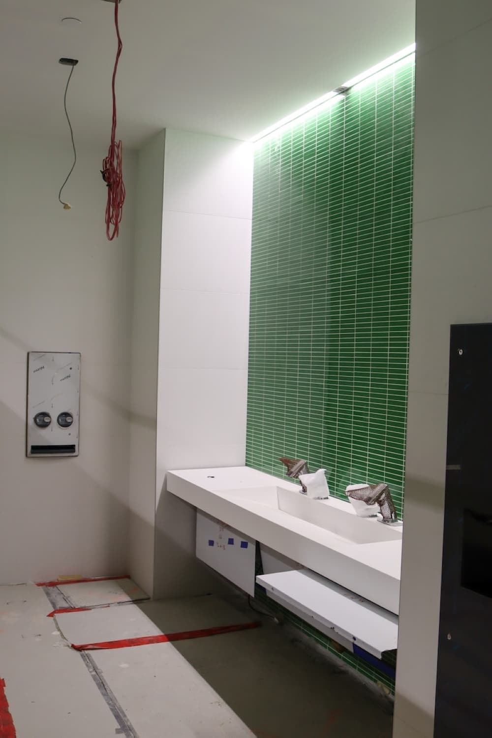 Restrooms are designed with the signature UNT green. (Grant Johnson/Community Impact Newspaper)