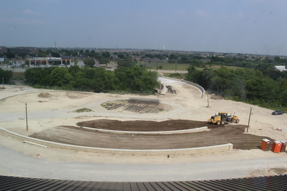 From the third floor of Frisco Landing, crews can be seen working on the front entrance to the UNT at Frisco campus. (Miranda Jaimes/Community Impact Newspaper)