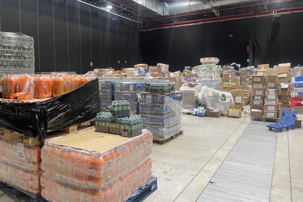 A warehouse is packed with pallets of supplies.