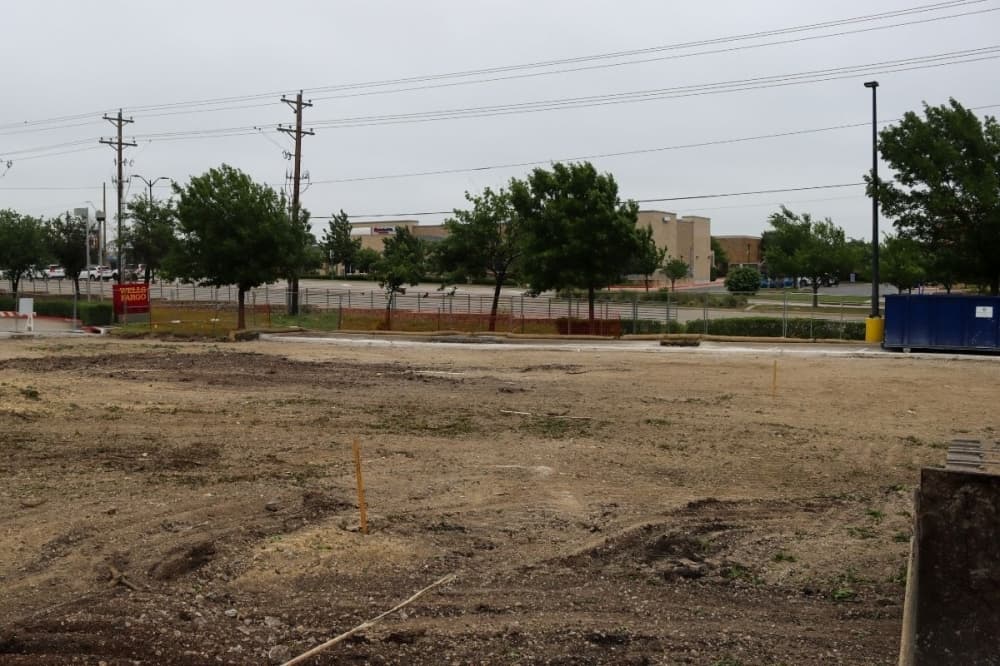  Concrete from an existing parking lot is being removed to prepare for the foundation of the HTeaO building to be constructed in McKinney. (Grant Johnson/Community Impact Newspaper)