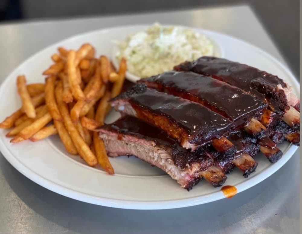 A slab of smoked ribs is served with two sides. (Courtesy Earnest B's BBQ & Catering)