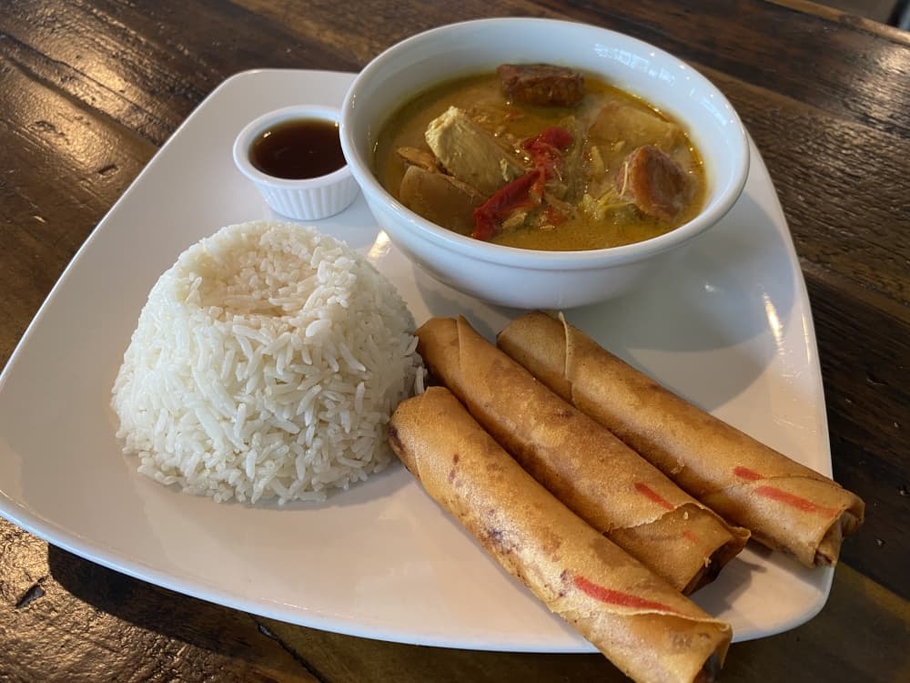 The chicken curry at Elsie's is a Filipino curry with potatoes and carrots, and it comes with egg rolls and rice. 