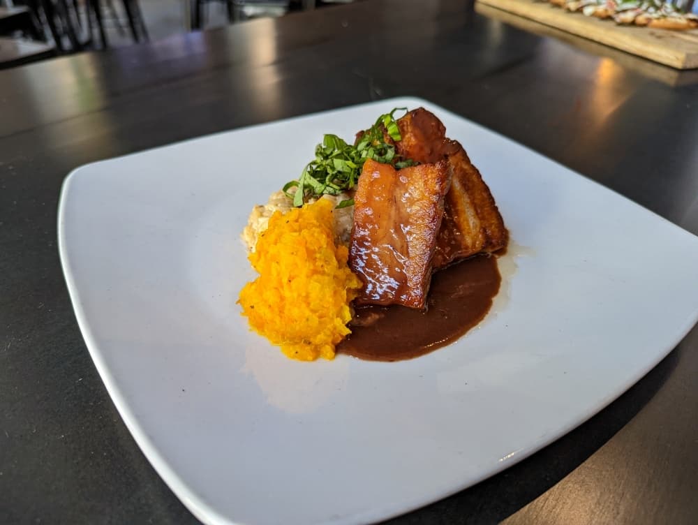 
The pork belly risotto ($14.99) is served on a bed of Parmesan risotto with a white wine reduction sauce and topped with veggie puree.