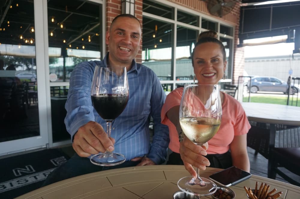Luis Gomez is a managing partner/general manager of d'Vine Wine Bar & Bistro, and Amy Vasquez is the owner. (Mikah Boyd/Community Impact Newspaper)