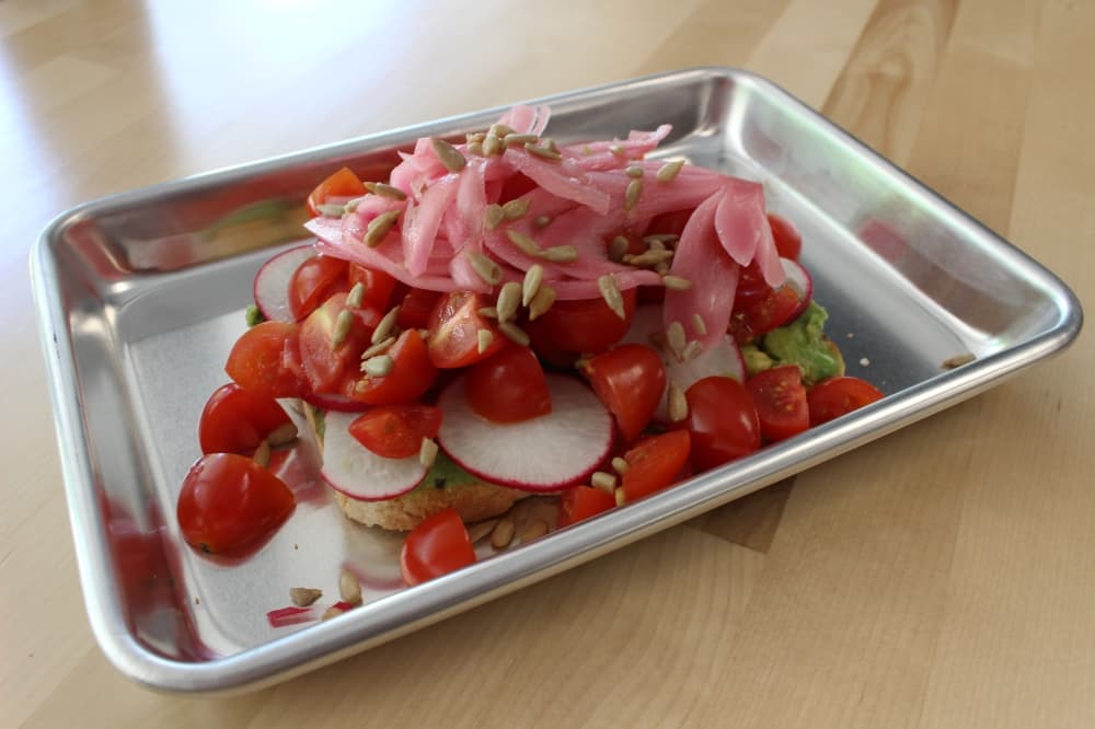 Garden toast ($9.75) is a new item added in early June featuring a variety of toppings.(Andrew Christman/Community Impact Newspaper)