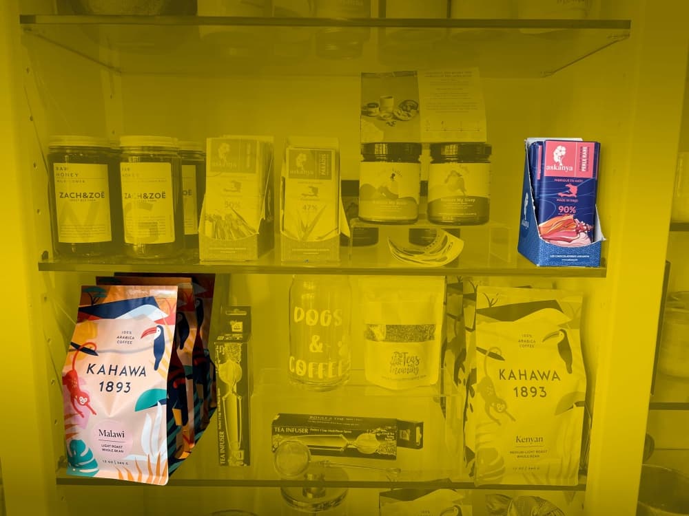 The shop sells products from all over the world that make empowering women of color a priority, such as Haiti-based ​​​​​​​bean-to-bar chocolate company Askanya Chocolate Co. and Kahawa 1893, coffee sourced from women farmers in Kenya and Rwanda. (Grace Dickens/Community Impact Newspaper)