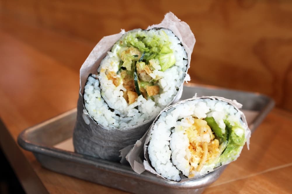The Crunch burrito ($12.95) has tempura shrimp, cucumber, cream cheese, green onion, avocado, sweet potato, spicy mayo and wonton strips. (Karen Chaney/Community Impact Newspaper)