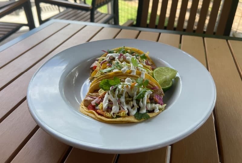 Blackened Mahi-Mahi with jalapeno slaw and lime crema are served on corn tortillas ($14). (Maegan Kirby/Community Impact Newspaper)