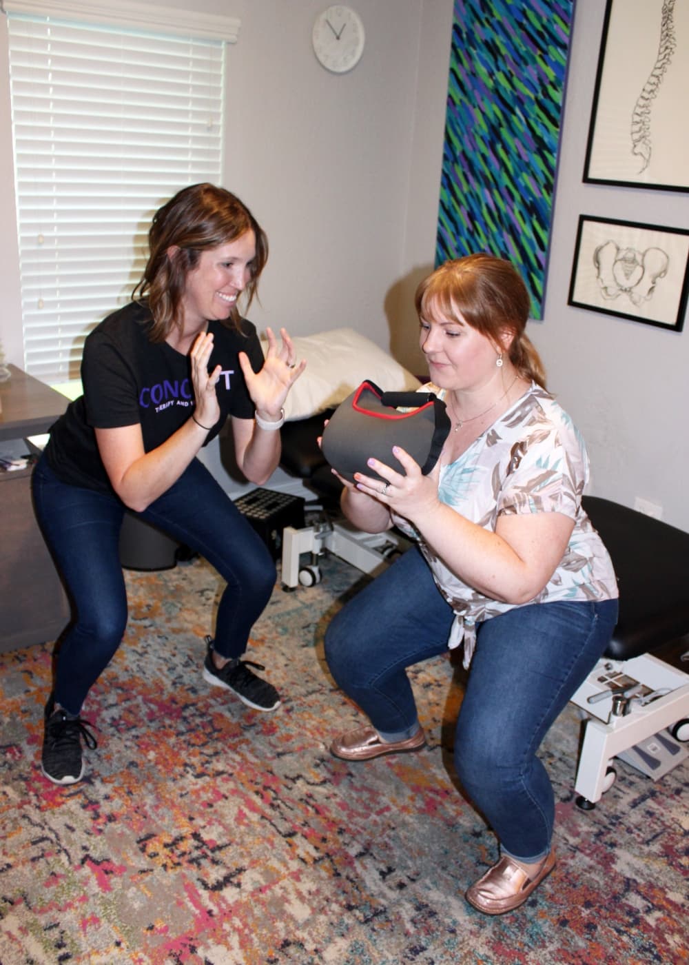 Stefanie Long (left) coaches patient model Natalie Moore on the proper form with squats, which are part of the functional exercises used during pelvic floor therapy. (Karen Chaney/Community Impact Newspaper)