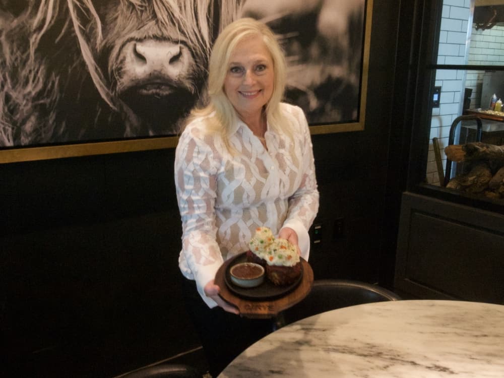 woman holding plate of food