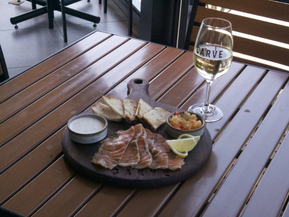 plate of salmon and glass of wine