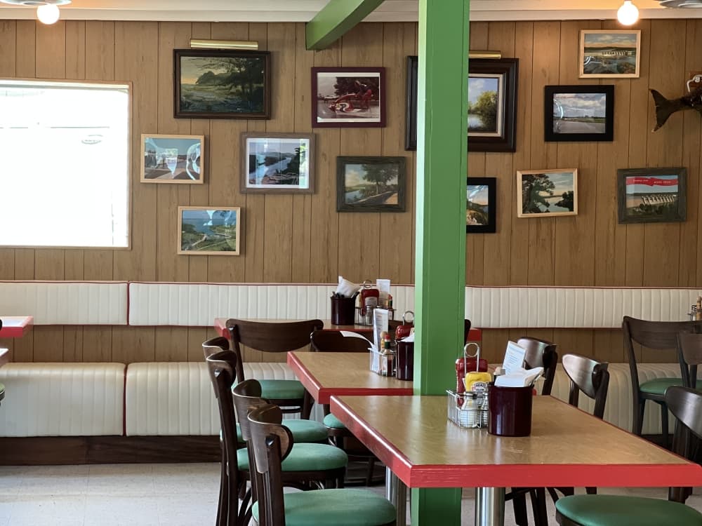 tables and pictures on wall of vintage restaurant