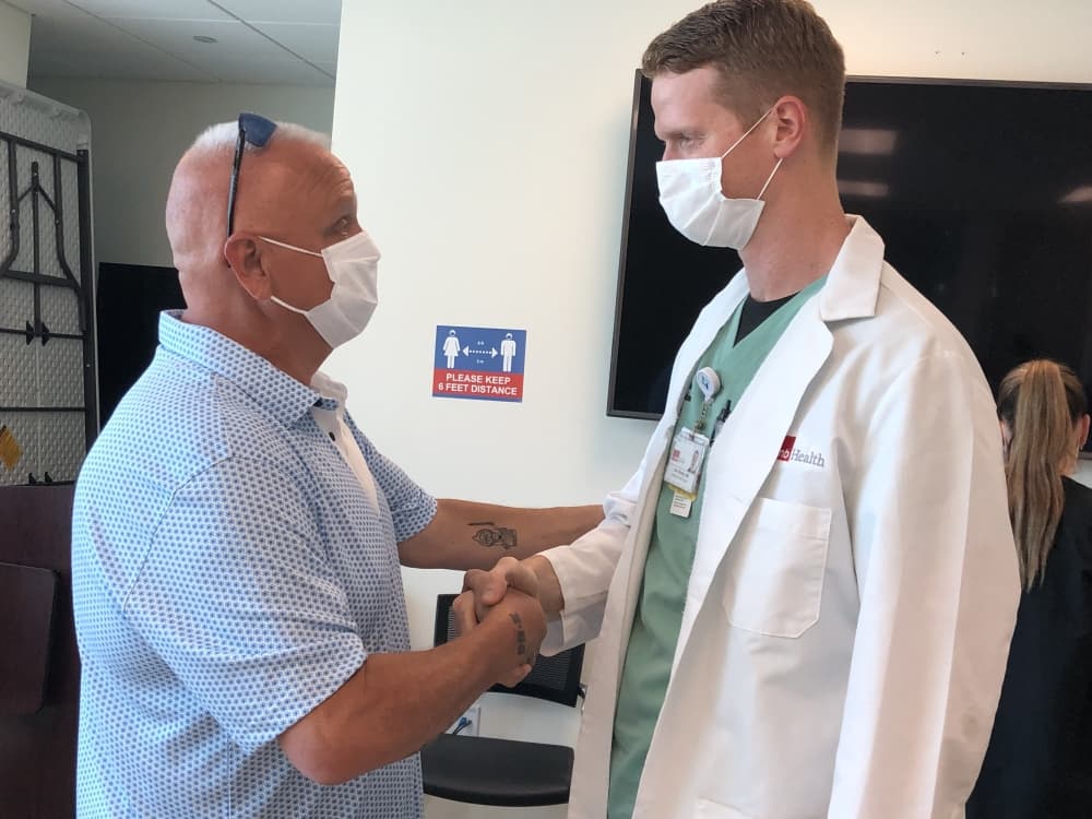 UTMB Health Emergency Medicine physician Dr. Nathanael Campbell (right) and Langdon Cassidy shake hands during recent reunion at the UTMB Health Clear Lake Hospital. Campbell was part of the team credited with saving Cassidy’s life back in May.