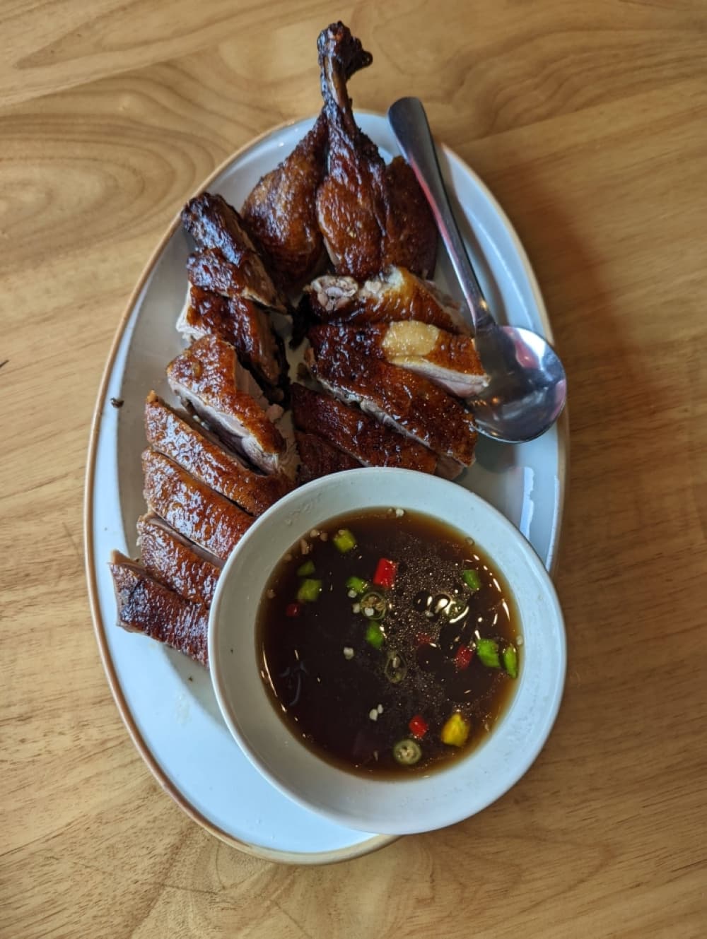 Sweet skinned duck ($22): Duck with a crystal sugar crust is served with chili dipping sauce. (George Wiebe/Community Impact Newspaper)