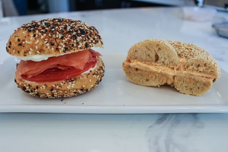 The Chairman ($11.50, left) features smoked salmon, capers, pickled red onion and cream cheese. Another menu item is a sesame bagel with jalapeno cream cheese ($4, right).